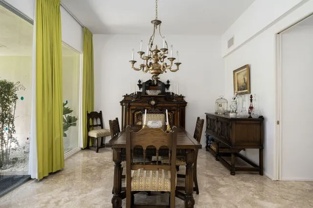 a view of a dining room with furniture and chandelier