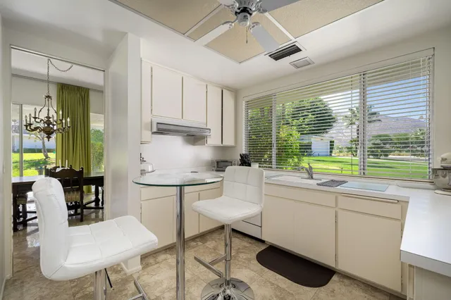a kitchen with a sink cabinets and window