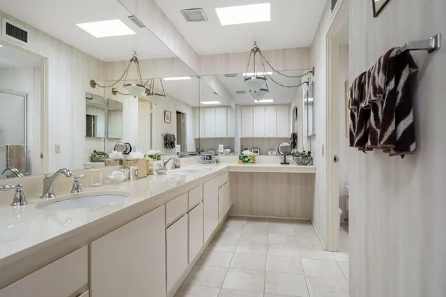 a large kitchen with a sink and cabinets