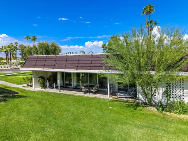 a view of a house with a yard porch and sitting area