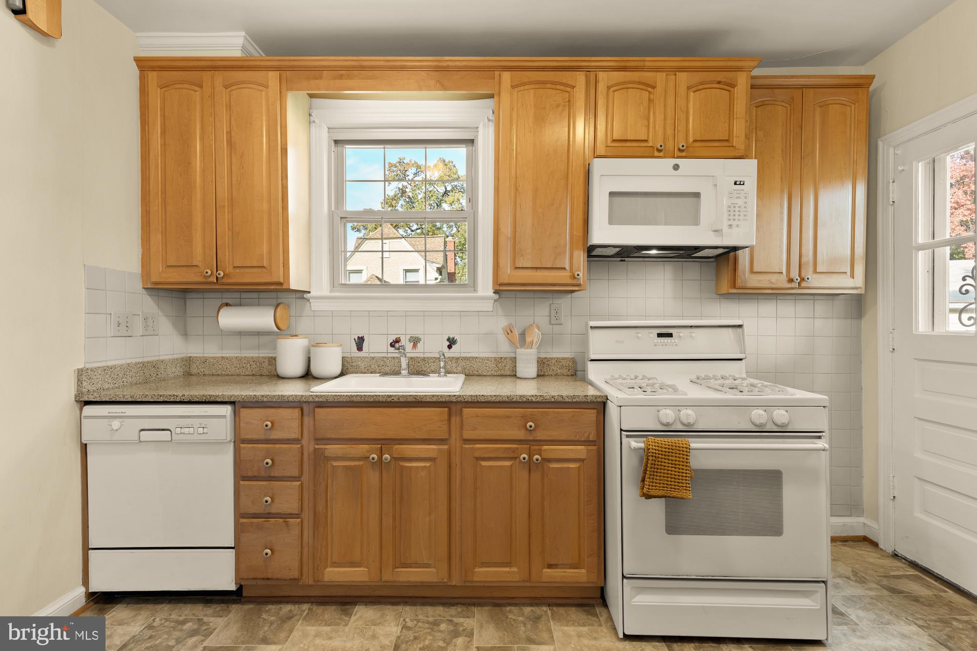 3141 Central Avenue Northeast Washington, DC 20018 - Photo 12 of 38 a kitchen with stainless steel appliances granite countertop a sink and cabinets