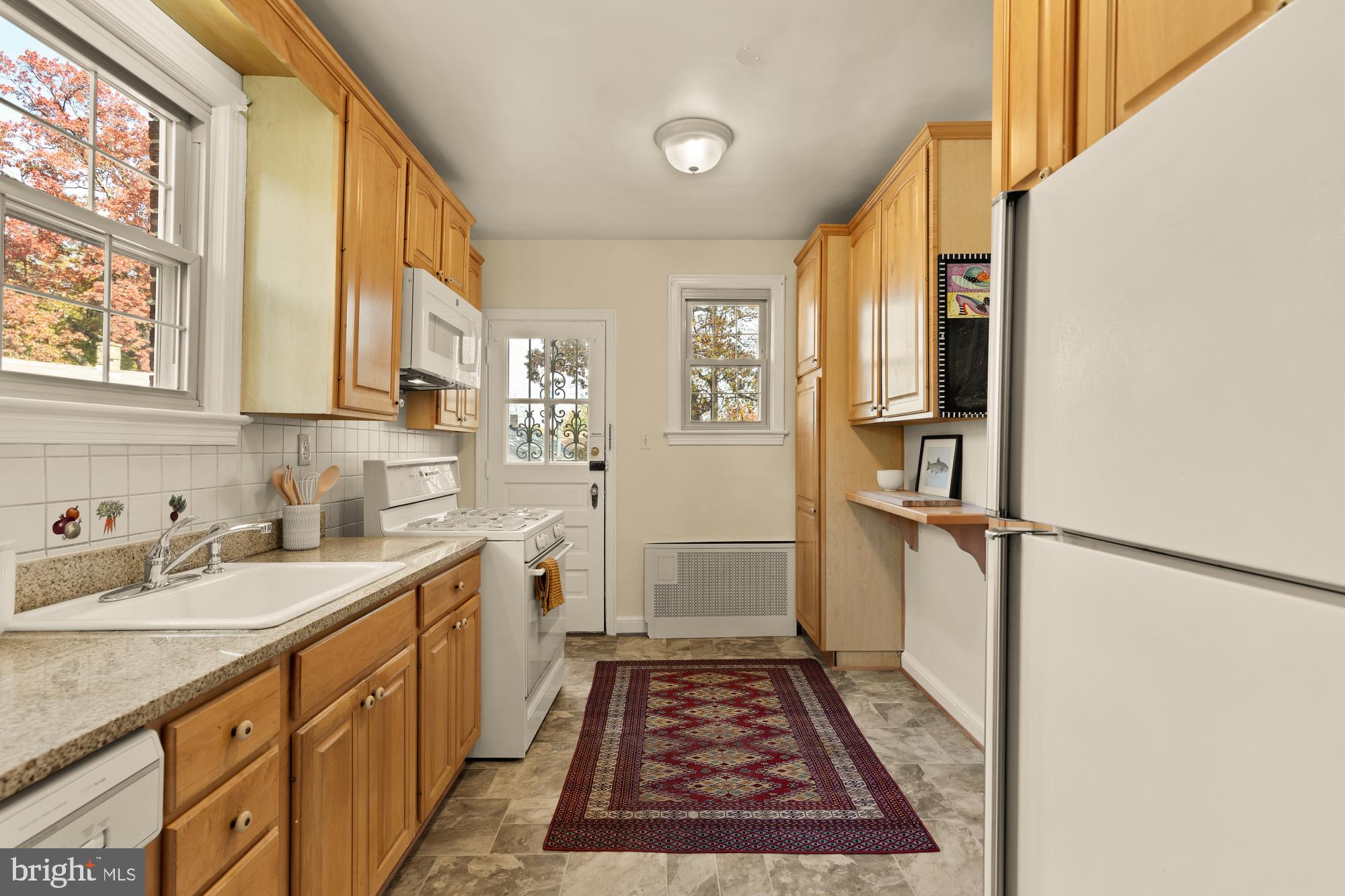 3141 Central Avenue Northeast Washington, DC 20018 - Photo 13 of 38 a view of a kitchen with a sink and dishwasher with wooden floor