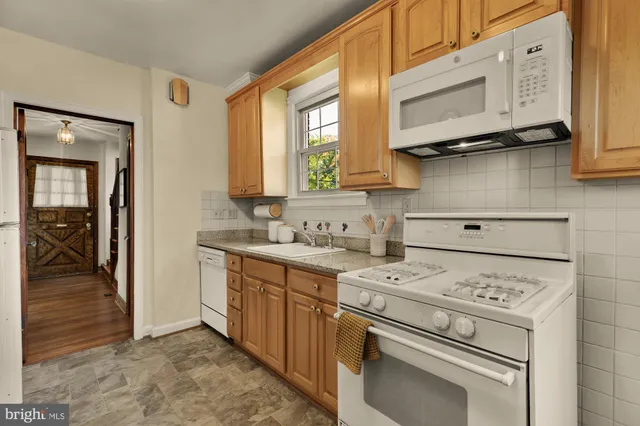 a kitchen with a stove cabinets and a sink