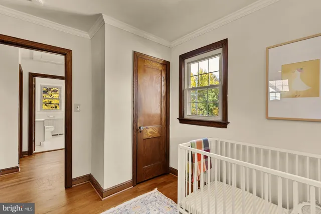 a view of a hallway with wooden floor and windows