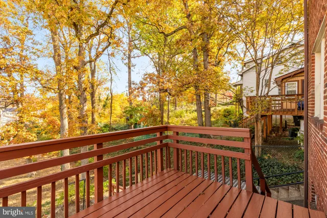 a view of balcony with wooden floor and outdoor seating