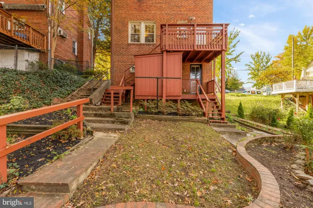 a view of a backyard with wooden fence