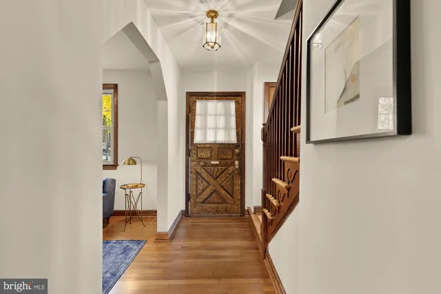 a view of a hallway with wooden floor and staircase