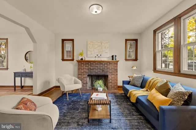 a living room with furniture fireplace and window