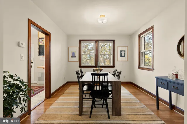 a view of a a dining room with furniture window and wooden floor