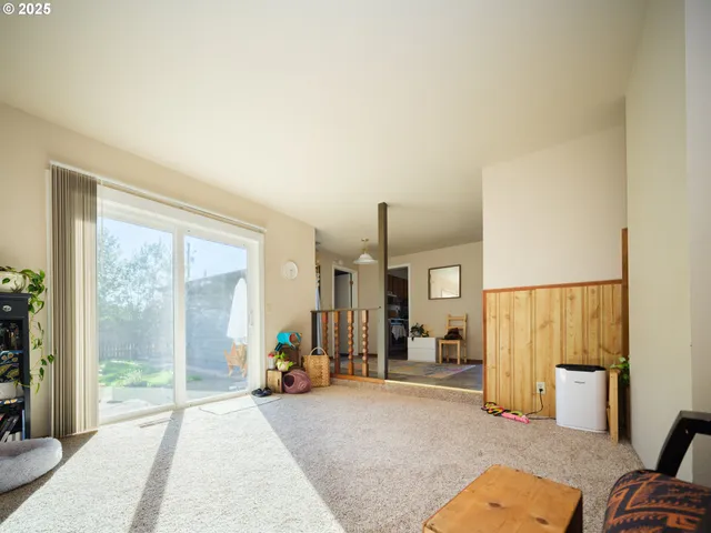 a view of a livingroom with furniture and a large window