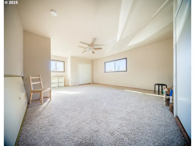 a view of livingroom with hardwood floor and a ceiling fan