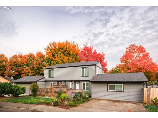 a front view of a house with a yard and a garage