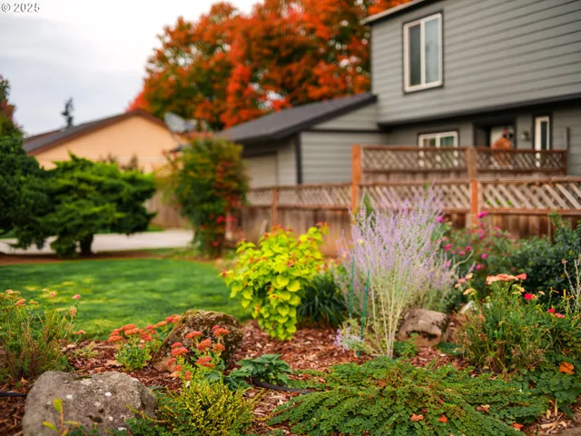 a front view of a house with a yard and fountain