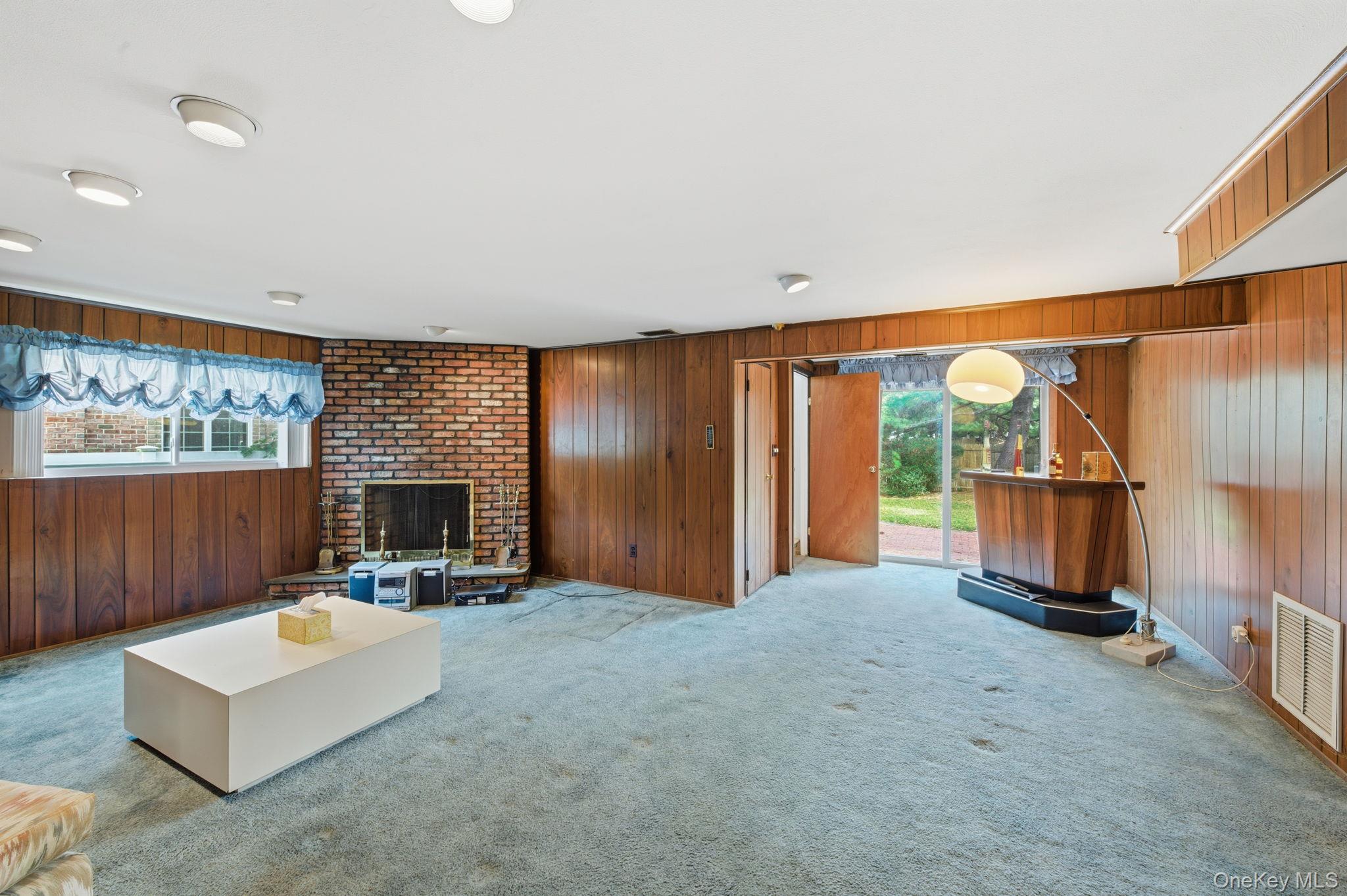 18 Dunhill Road Manhasset Hills, NY 11040 - Photo 14 of 20 a view of an empty room with a fireplace