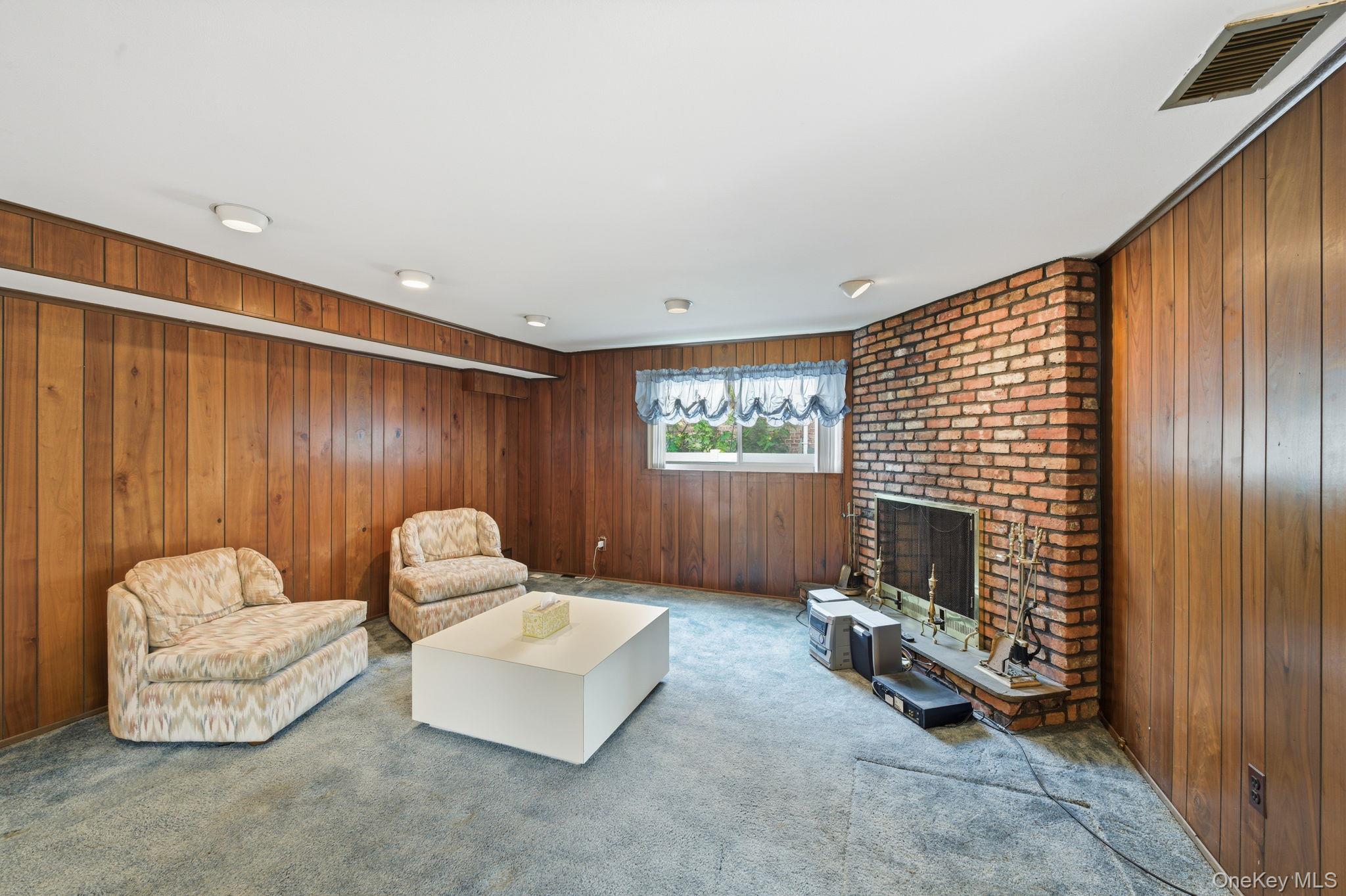 18 Dunhill Road Manhasset Hills, NY 11040 - Photo 15 of 20 a living room with furniture and a fireplace