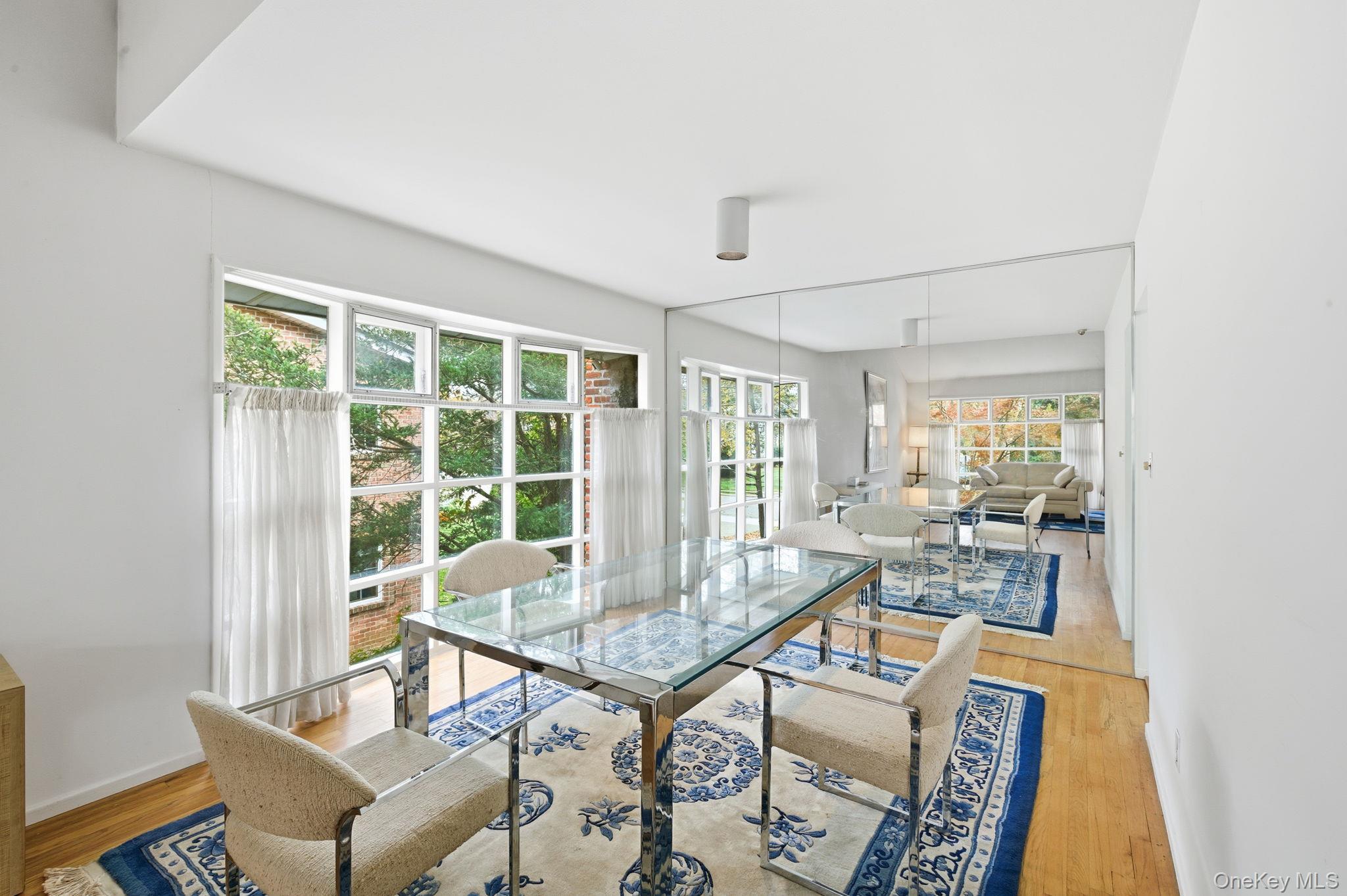 18 Dunhill Road Manhasset Hills, NY 11040 - Photo 6 of 20 a living room with furniture and a large window