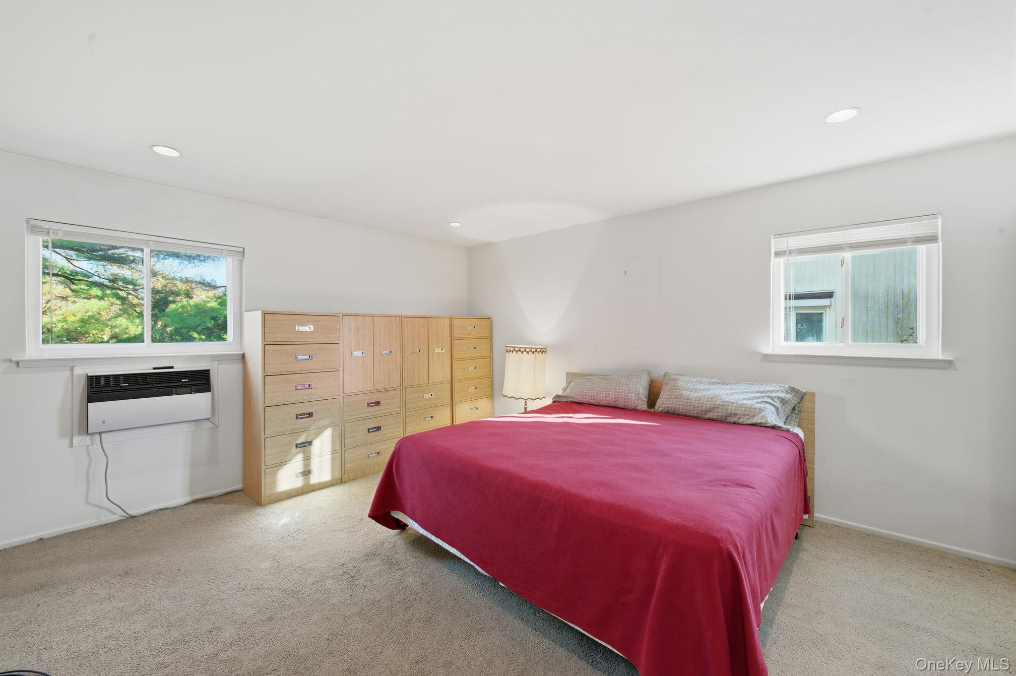 18 Dunhill Road Manhasset Hills, NY 11040 - Photo 9 of 20 a bedroom with a bed and a stove