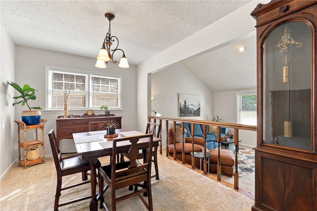 7 Woodbridge Circle Anderson, SC 29621 - Photo 8 of 26 An open dining area overlooks the sunken living room through an elegant wooden railing.