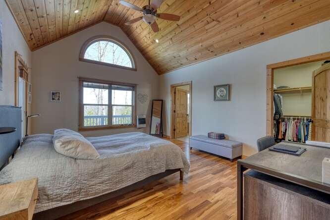 2081 Gallatin Road Young Harris, GA 30582 - Photo 14 of 44 a bedroom with a bed and a dresser next to a window