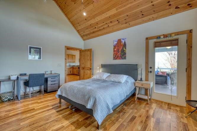2081 Gallatin Road Young Harris, GA 30582 - Photo 16 of 44 a spacious bedroom with a bed and wooden floor