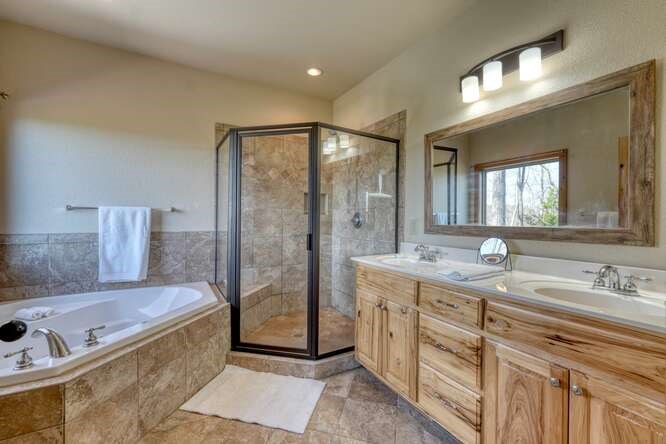 2081 Gallatin Road Young Harris, GA 30582 - Photo 17 of 44 a spacious bathroom with a granite countertop sink mirror and bathtub