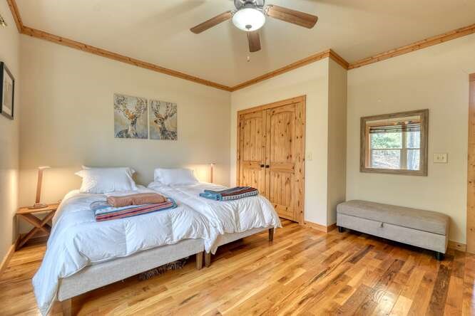 2081 Gallatin Road Young Harris, GA 30582 - Photo 21 of 44 a bedroom with a bed and a chandelier