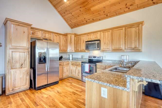 2081 Gallatin Road Young Harris, GA 30582 - Photo 9 of 44 a kitchen with granite countertop a refrigerator and a sink