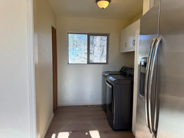 a kitchen with a refrigerator and cabinets