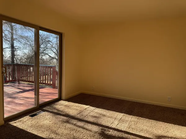 a view of a room with wooden floor and a view of balcony