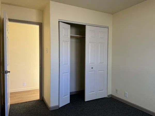 a bathroom with a granite countertop toilet a sink and a shower