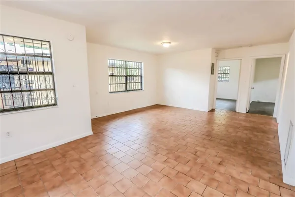 an empty room with windows and closet