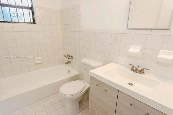 a bathroom with a sink a toilet and bathtub