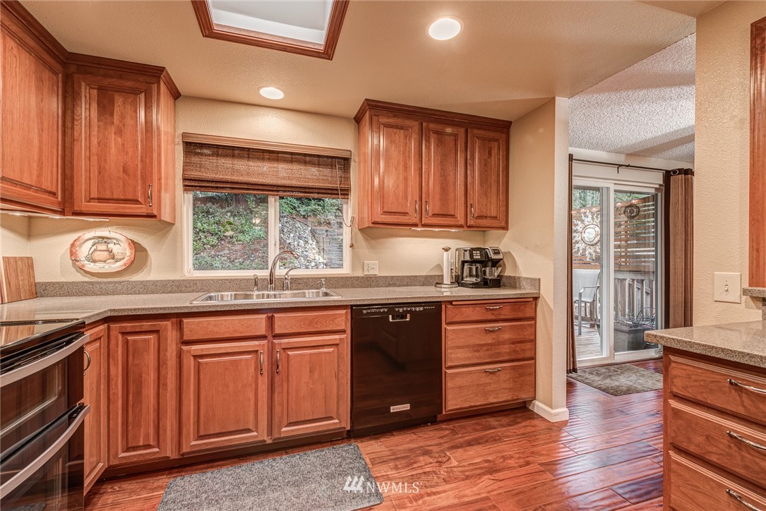 2001 172nd Place Southeast Bothell, WA 98012 - Photo 8 of 32 a kitchen with a sink window and cabinets