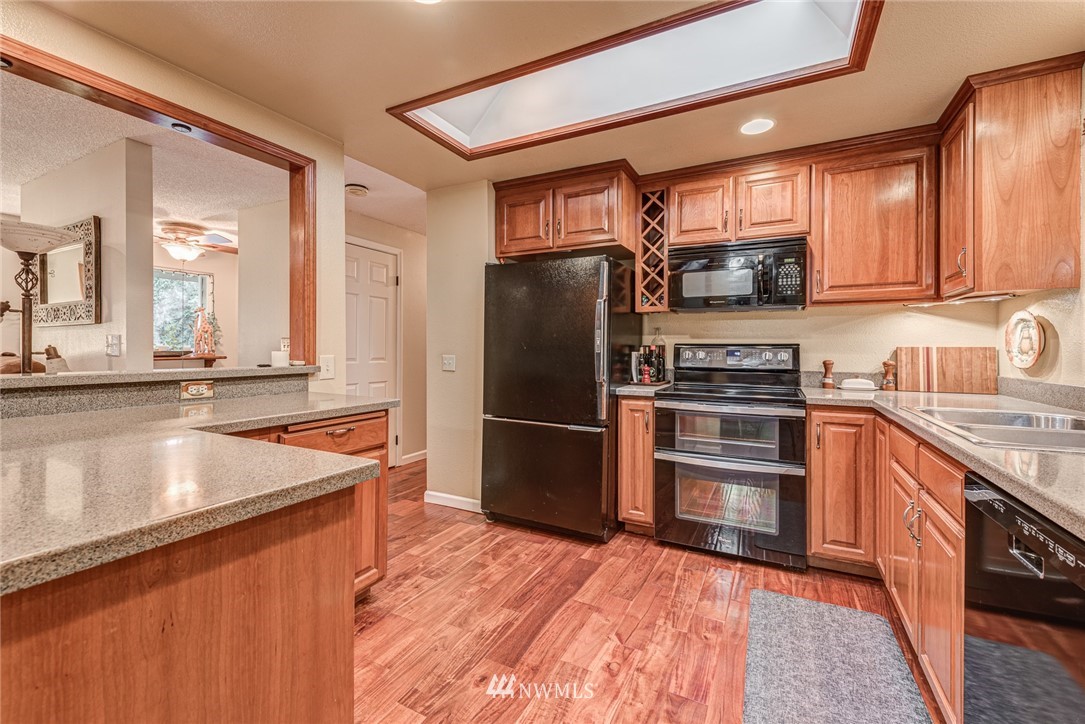 2001 172nd Place Southeast Bothell, WA 98012 - Photo 9 of 32 a kitchen with stainless steel appliances granite countertop a refrigerator stove and sink