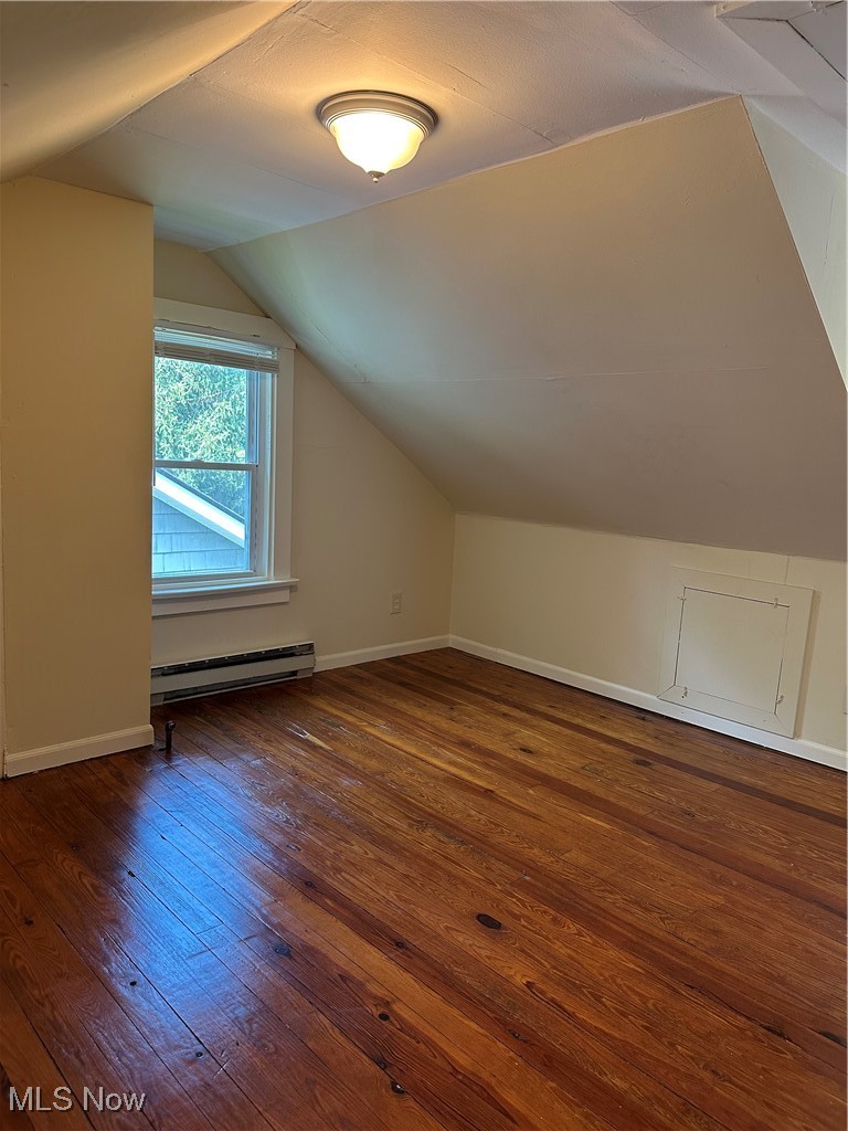 1596 Wood Road Cleveland Heights, OH 44121 - Photo 14 of 25 Bonus room with wood-type flooring, vaulted ceiling, and a baseboard radiator