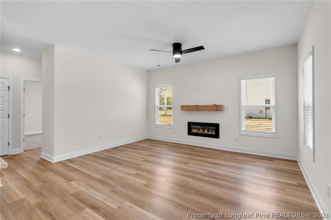 131 Merle Road Pinebluff, NC 28373 - Photo 7 of 33 an empty room with windows and fireplace