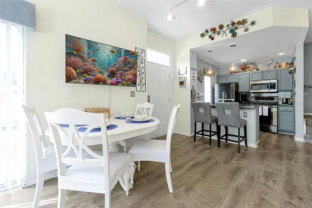 a view of a dining room with furniture and wooden floor