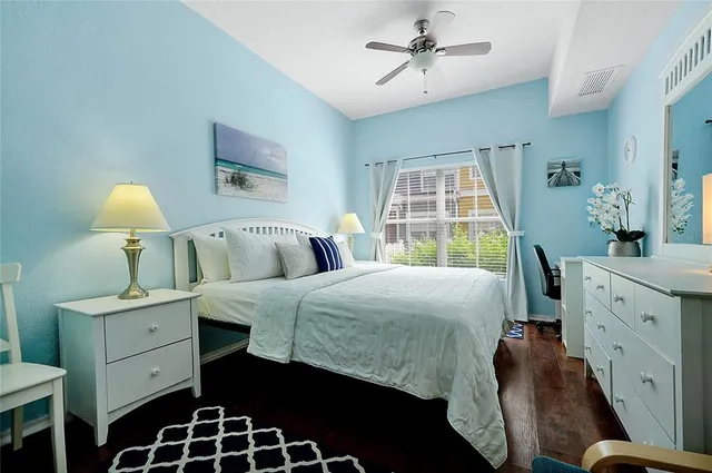 a spacious bedroom with a bed and a dresser