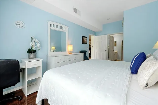 a bedroom with a bed and a chair