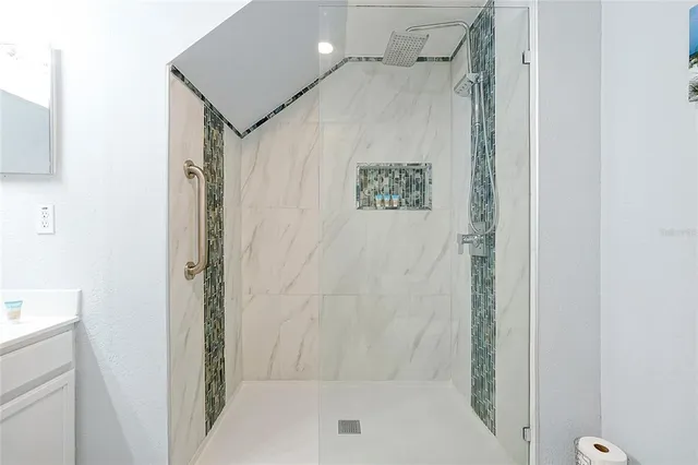 a bathroom with a shower and a sink