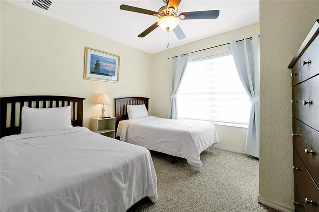 a bedroom with two beds and a window