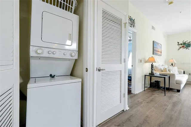 a white house covered with tall trees