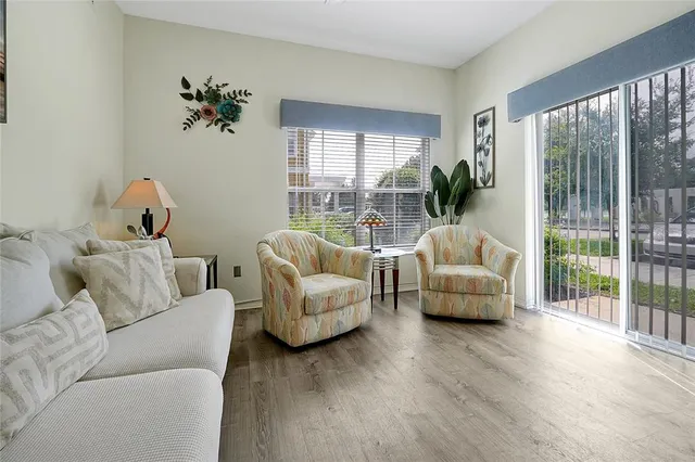 a living room with furniture and a large window with outer view