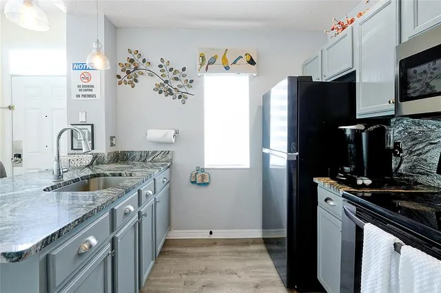 a kitchen with a sink stove and refrigerator