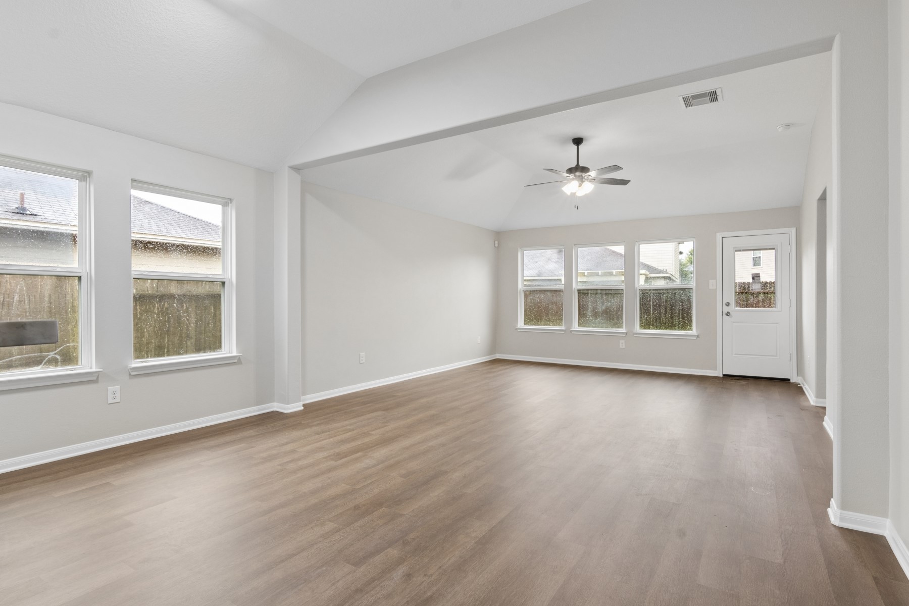 7811 Adonis Avenue Baytown, TX 77521 - Photo 11 of 36 an empty room with wooden floor and windows