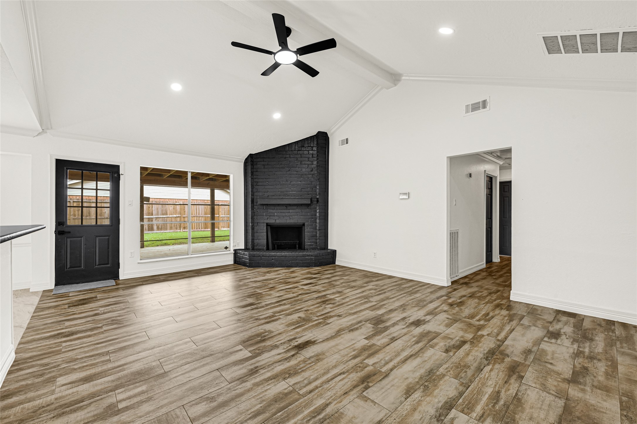 4102 Townes Forest Road Friendswood, TX 77546 - Photo 2 of 50 Bright and open living space featuring wood-style flooring, modern ceiling fan, and plenty of natural light.