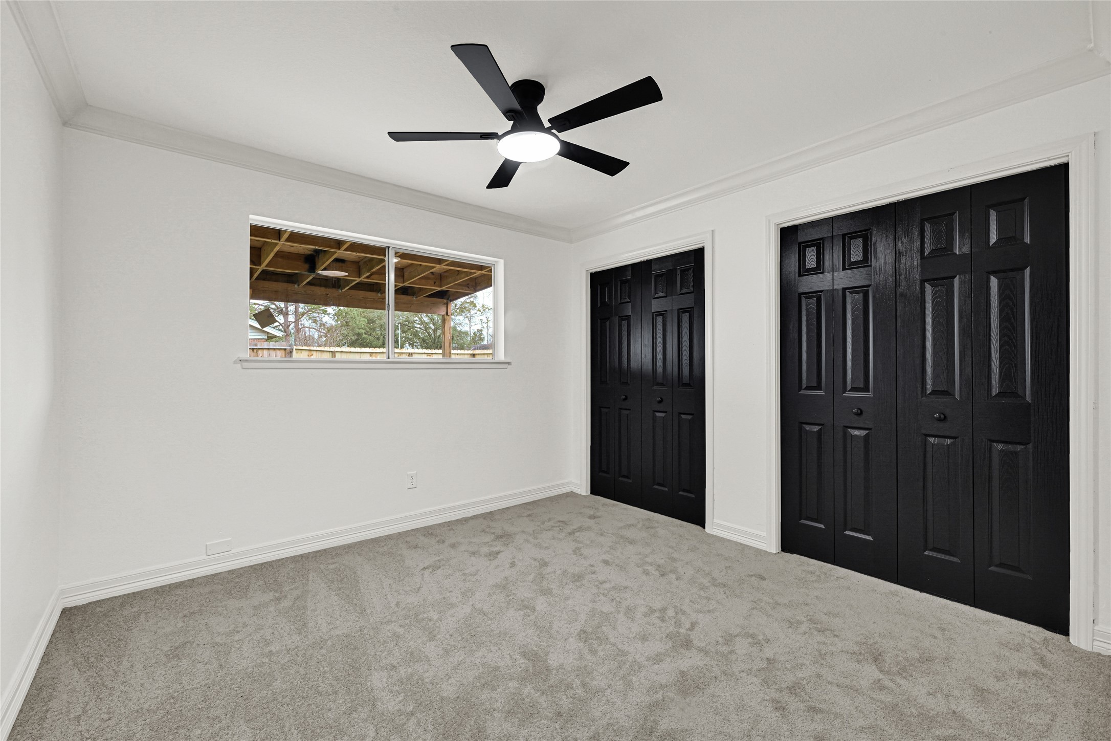 4102 Townes Forest Road Friendswood, TX 77546 - Photo 23 of 50 Well-sized bedroom featuring multiple closets and a ceiling fan for added comfort.