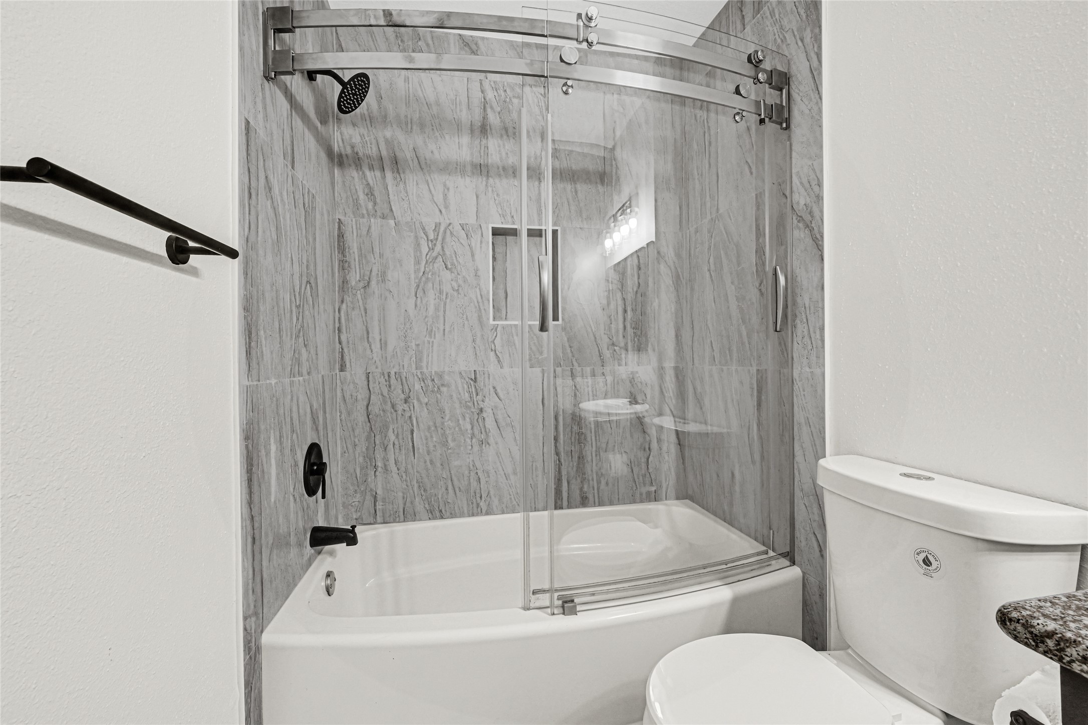 4102 Townes Forest Road Friendswood, TX 77546 - Photo 27 of 50 Updated bathroom featuring stylish tile work and a clean tub/shower combination.