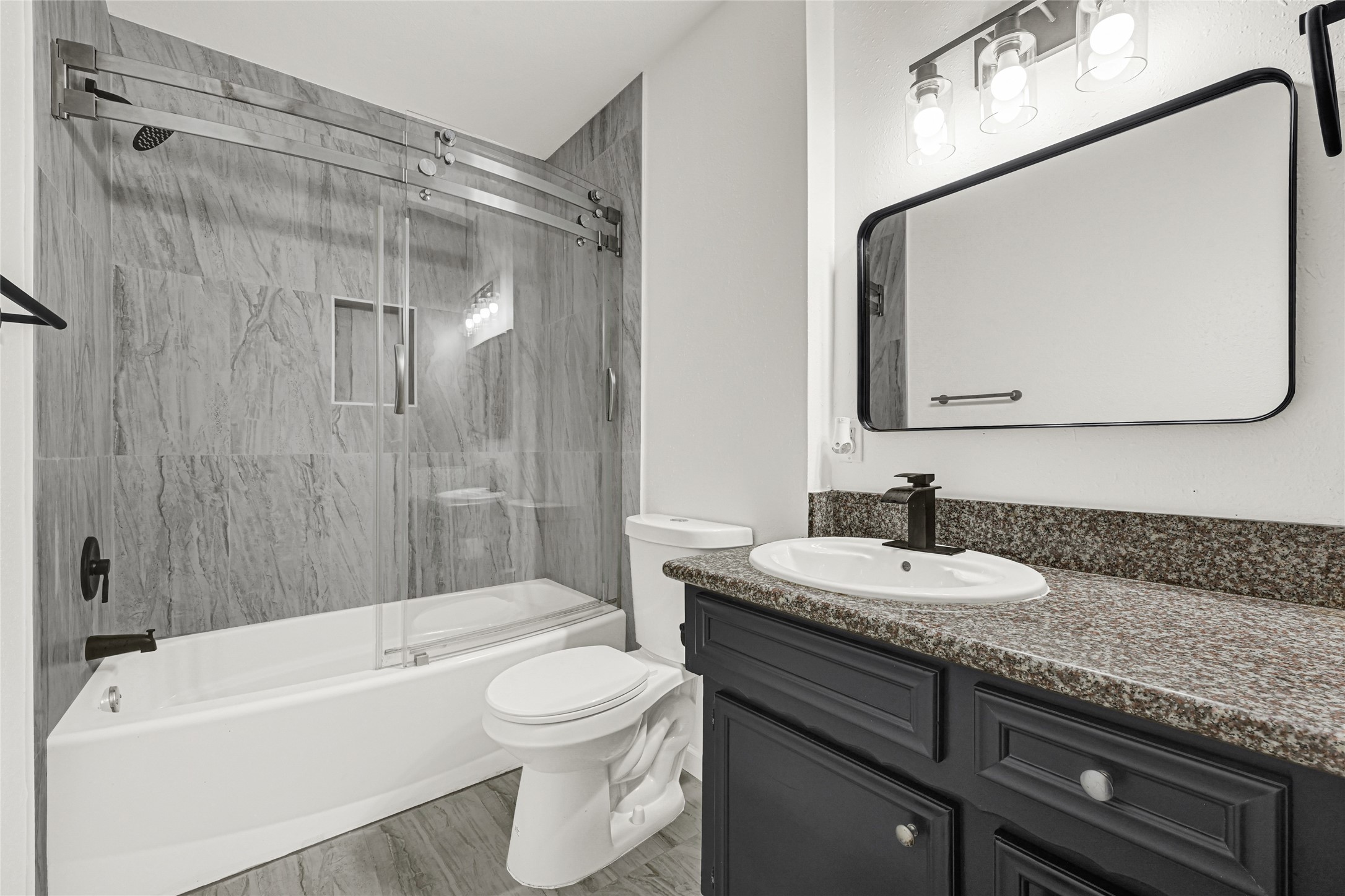 4102 Townes Forest Road Friendswood, TX 77546 - Photo 4 of 50 Stylish bathroom with contemporary tile work, updated vanity, and a clean, refreshed look.