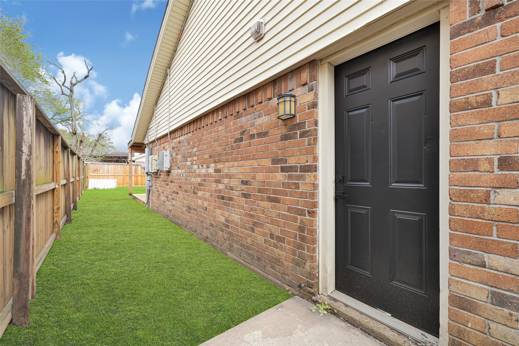4102 Townes Forest Road Friendswood, TX 77546 - Photo 41 of 50 Side yard view showcasing durable brick exterior and additional outdoor space.